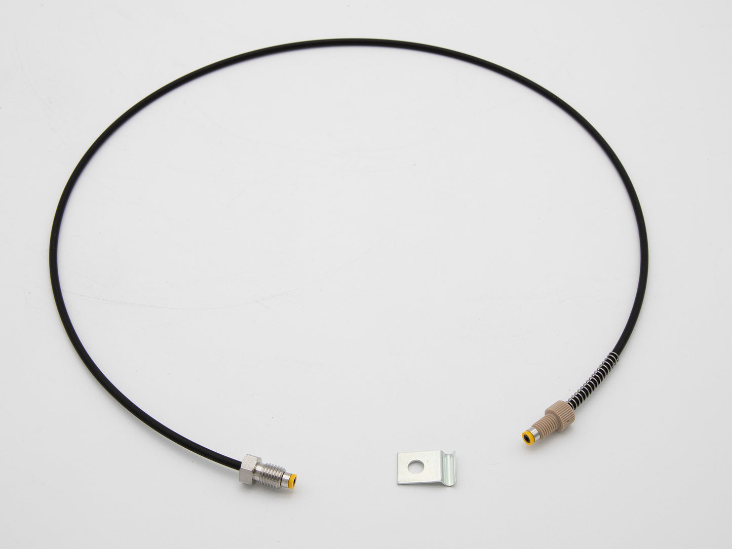 Black tubing with connectors attached, alongside a small metallic piece, highlighting its technical aspects.