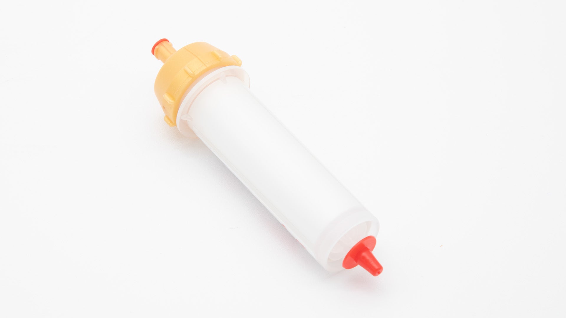A small white tube with gold and red caps displayed on a white background, creating a striking visual contrast between the two elements.