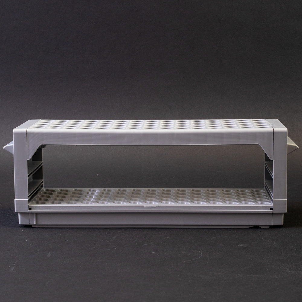 A gray plastic shelf with perforated design, allowing for location and storage of vials.