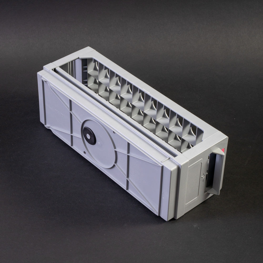 A gray plastic shelf with perforated design, allowing for location and storage of vials.