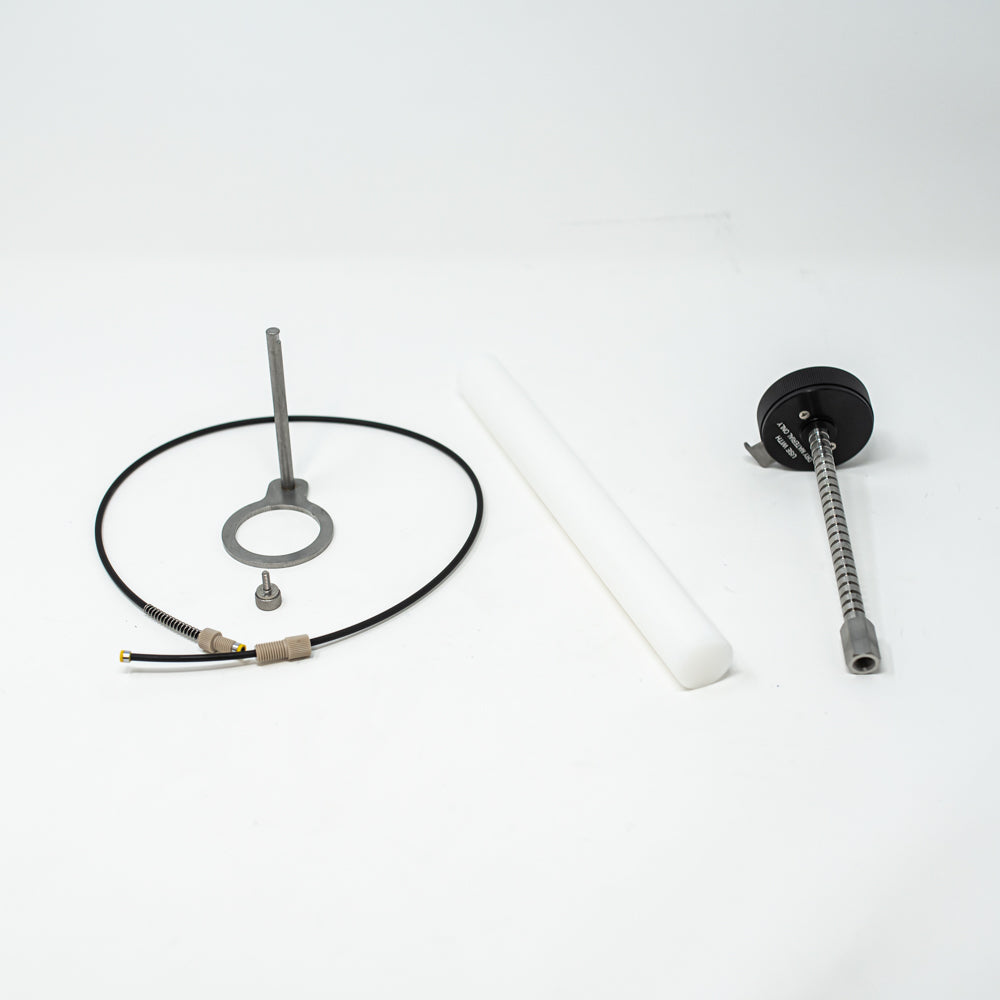 A stainless steel object featuring a sleek rod, showcasing a minimalist design and modern aesthetic.