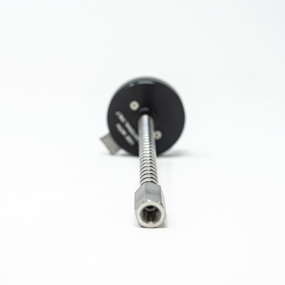 A stainless steel object featuring a sleek rod, showcasing a minimalist design and modern aesthetic.