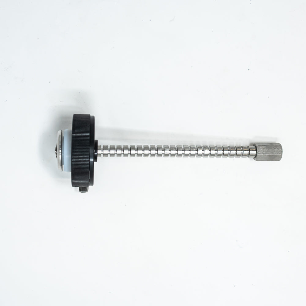A stainless steel object featuring a sleek rod, showcasing a minimalist design and modern aesthetic.