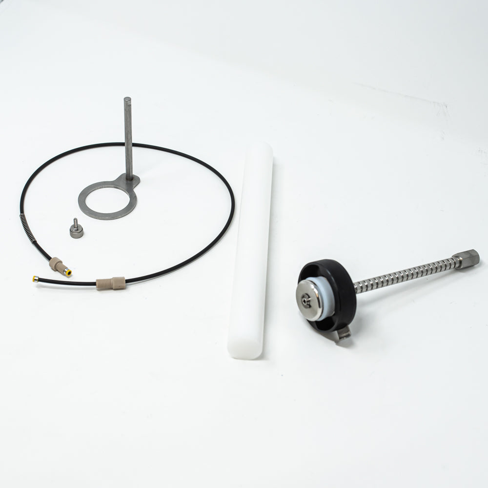 A stainless steel object featuring a sleek rod, showcasing a minimalist design and modern aesthetic.