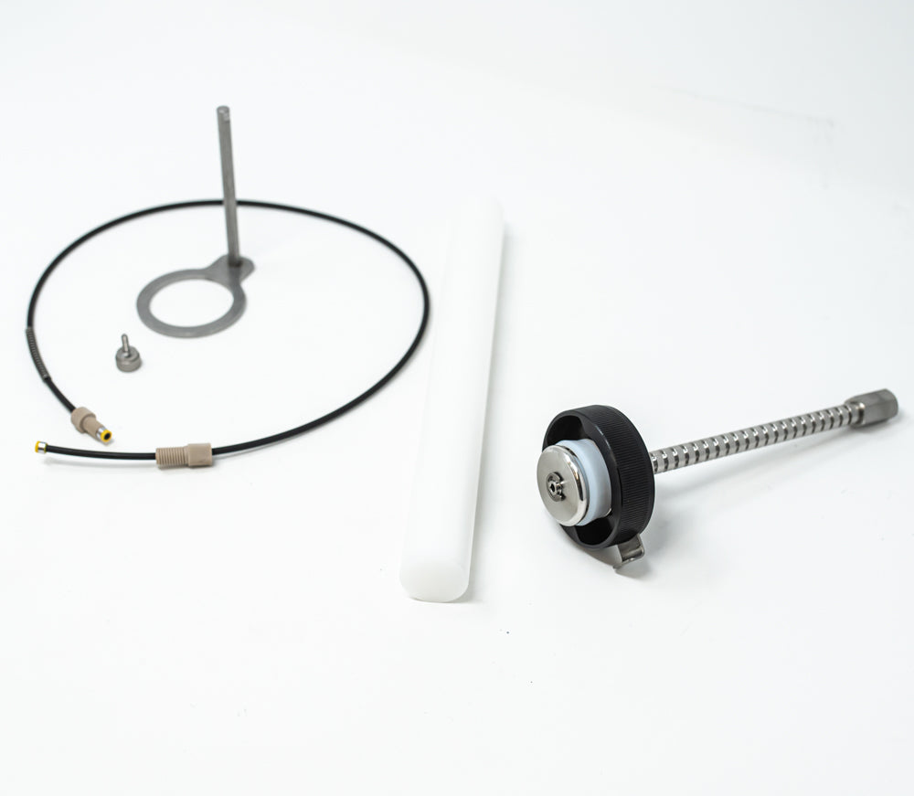 A stainless steel object featuring a sleek rod, showcasing a minimalist design and modern aesthetic.