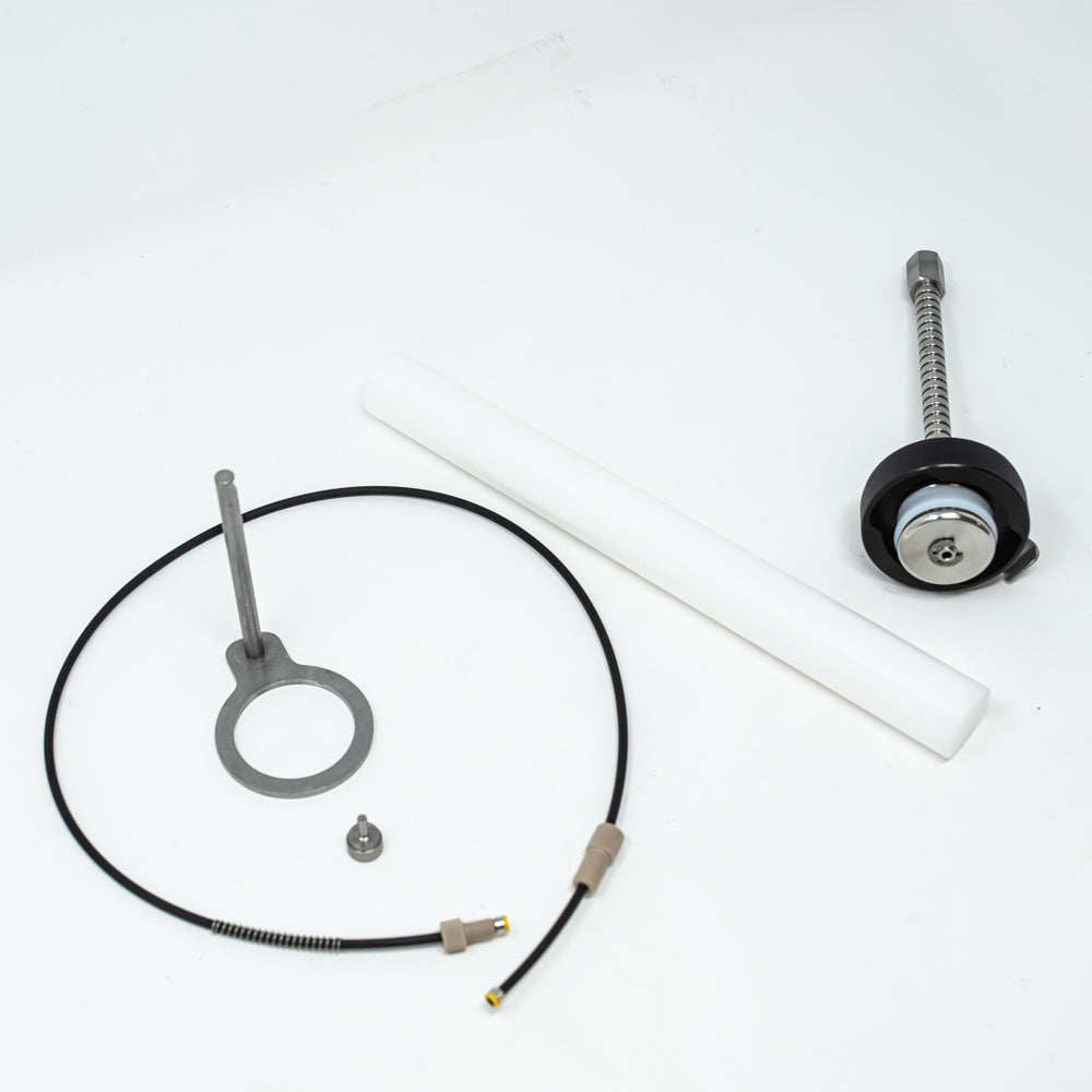 A stainless steel object featuring a sleek rod, showcasing a minimalist design and modern aesthetic.