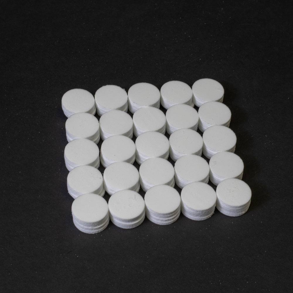 A cluster of white circular objects positioned on a black surface.