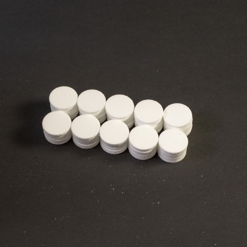 A cluster of white circular objects positioned on a black surface.