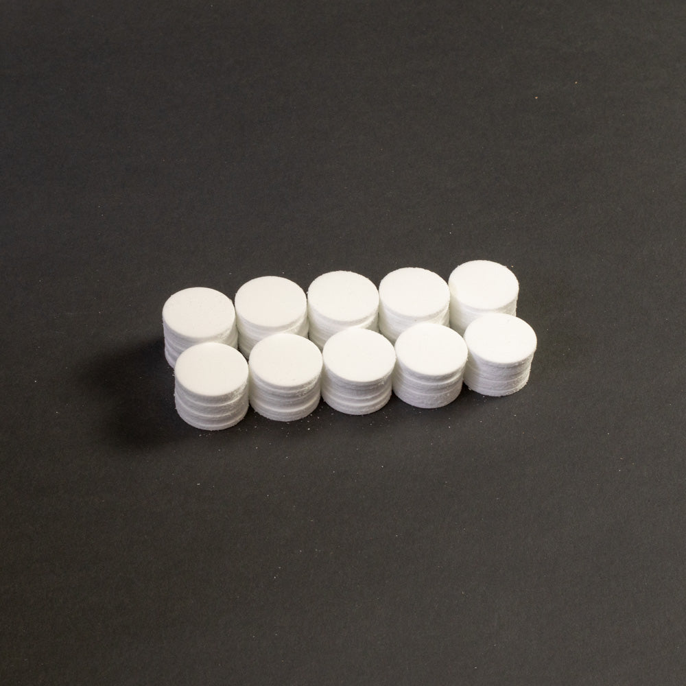 A cluster of white circular objects positioned on a black surface.