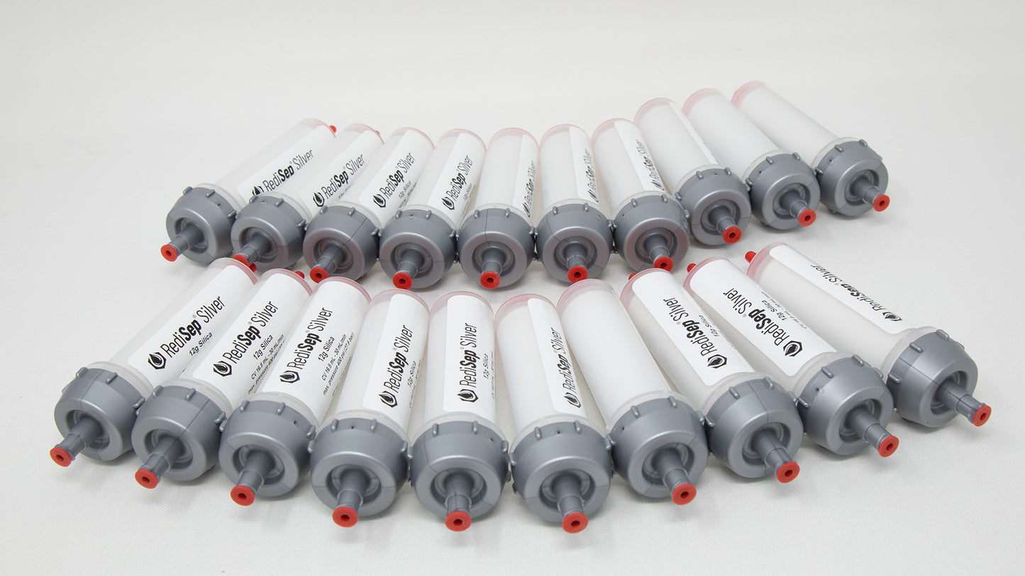 A group of plastic tubes with red and silver caps, positioned side by side, emphasizing their contrasting colors and forms.