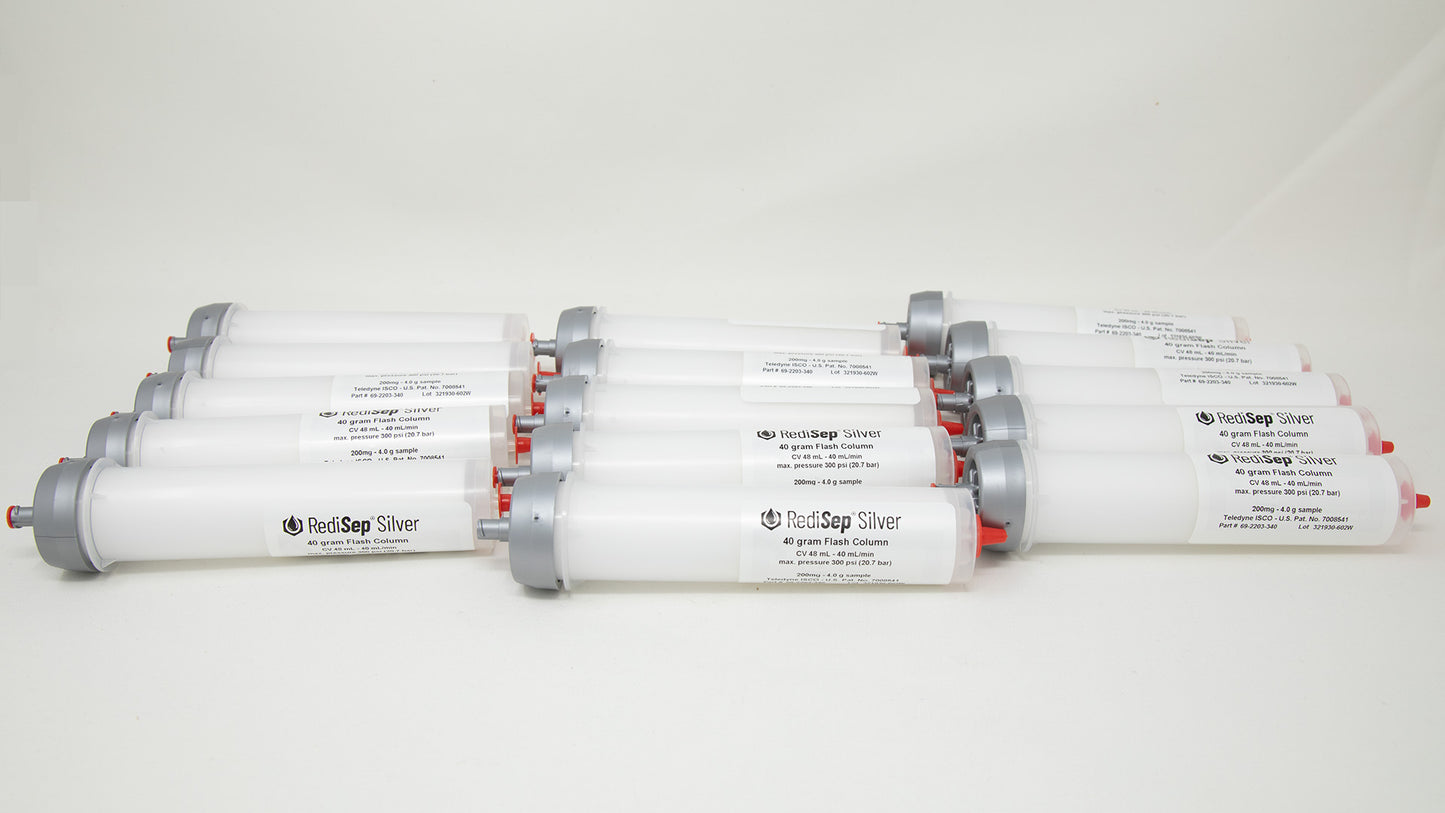 A group of plastic tubes with red and silver caps, positioned side by side, emphasizing their contrasting colors and forms.