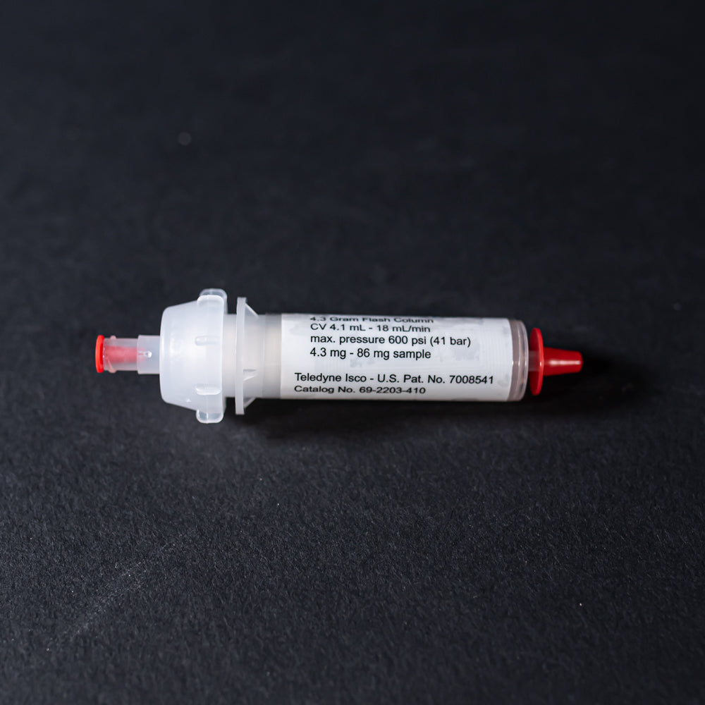 A white tube with red caps displayed on a black background, creating a striking visual contrast between the two elements.