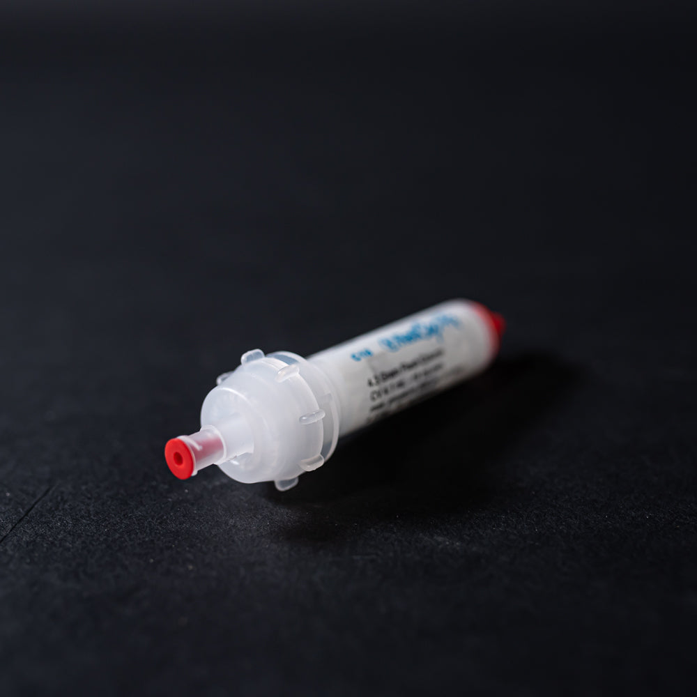 A white tube with red caps displayed on a black background, creating a striking visual contrast between the two elements.