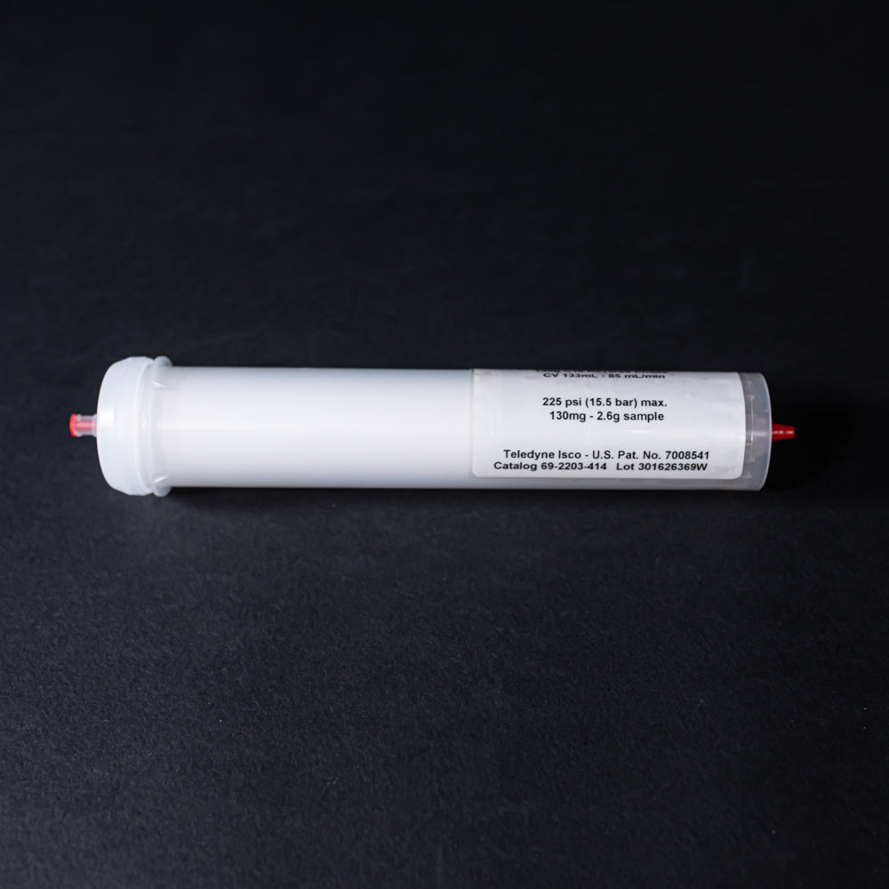 A small white tube with red caps displayed on a black background, creating a striking visual contrast between the two elements.