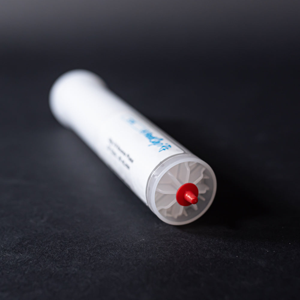 A small white tube with red caps displayed on a black background, creating a striking visual contrast between the two elements.