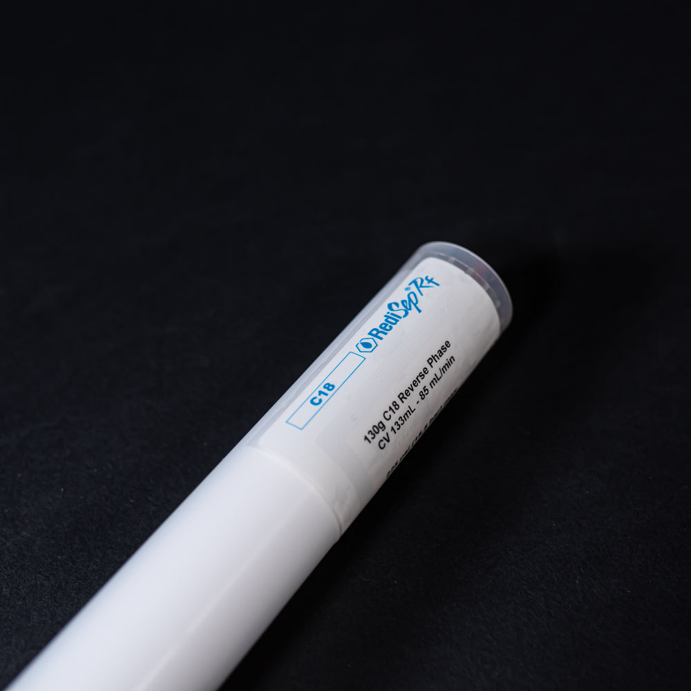 A small white tube with displayed on a black background, creating a striking visual contrast between the two elements.