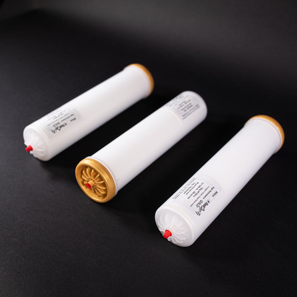 A group of small white tubes with gold and red caps displayed on a black background, creating a striking visual contrast between the two elements.