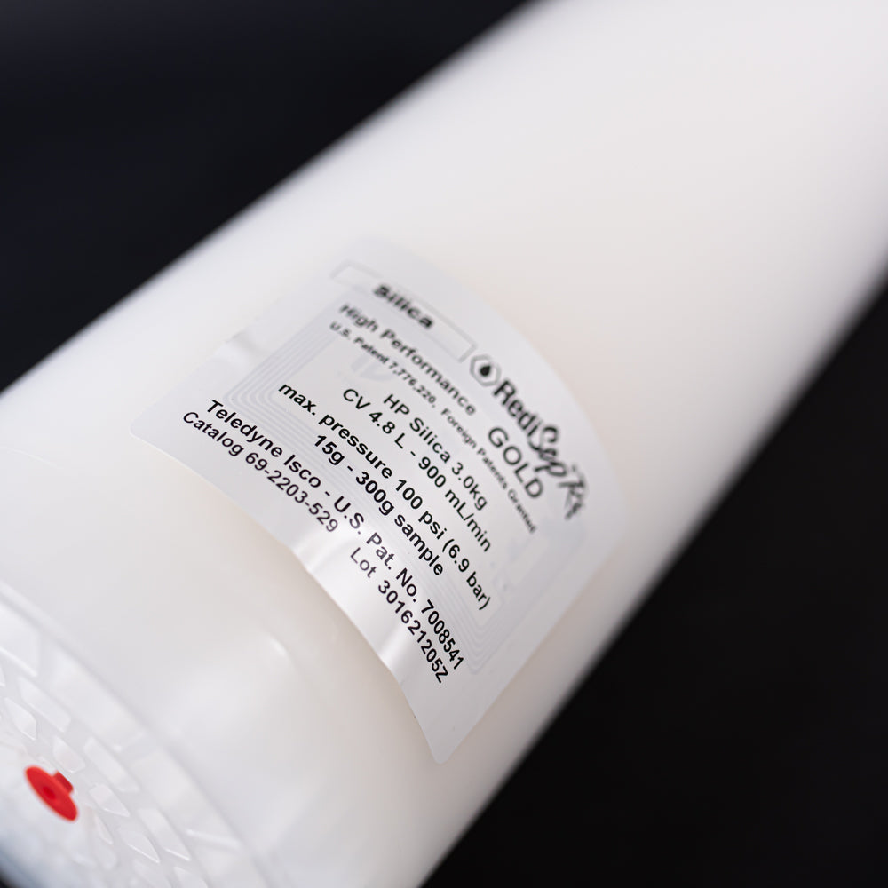 A small white tube with red cap displayed on a black background, creating a striking visual contrast between the two elements.