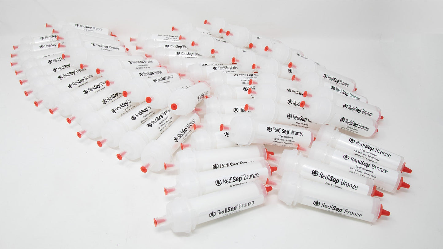 A group of plastic tubes with red caps, positioned side by side, emphasizing their contrasting colors and forms.