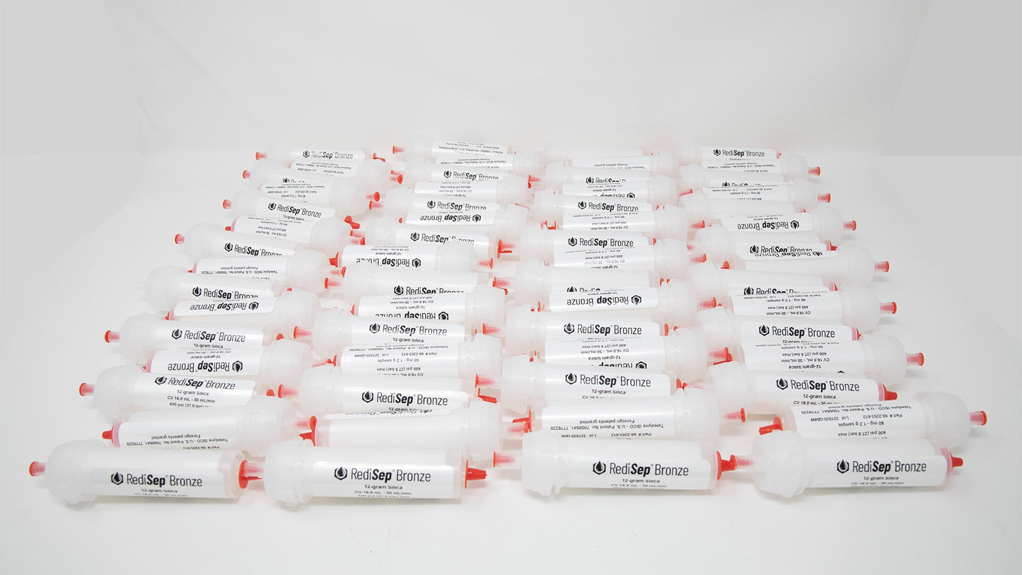 A group of plastic tubes with red caps, positioned side by side, emphasizing their contrasting colors and forms.