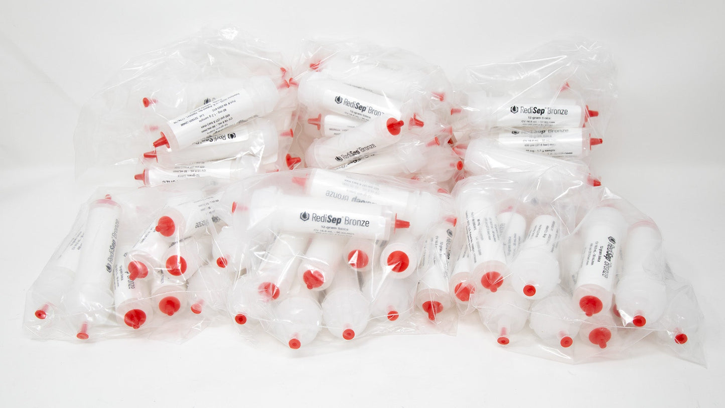 A group of plastic tubes with red caps, positioned side by side, emphasizing their contrasting colors and forms.