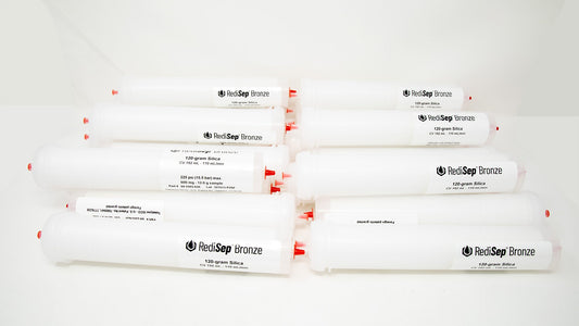 A group of plastic tubes with red caps, positioned side by side, emphasizing their contrasting colors and forms.