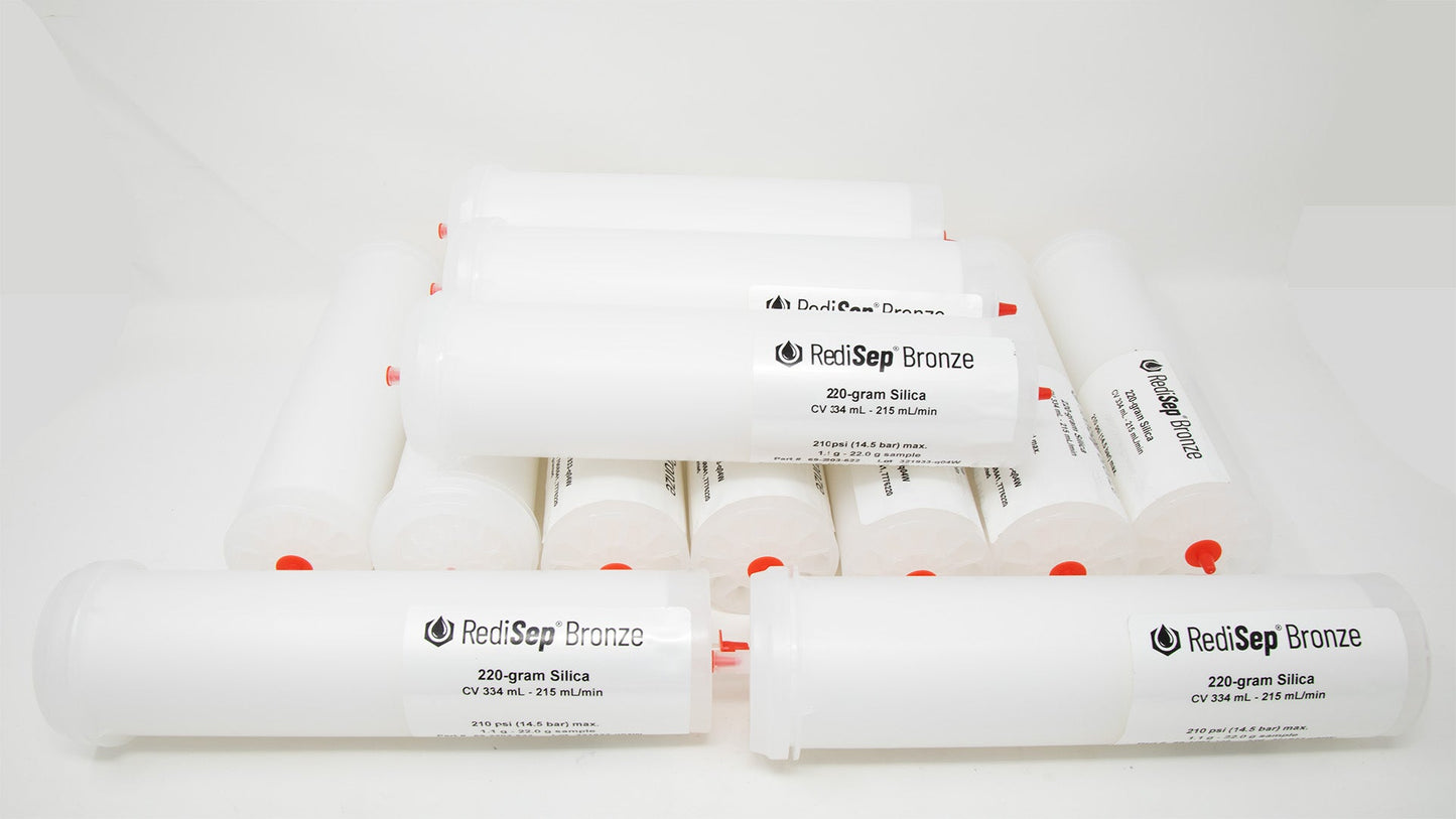 A group of plastic tubes with red caps, positioned side by side, emphasizing their contrasting colors and forms.