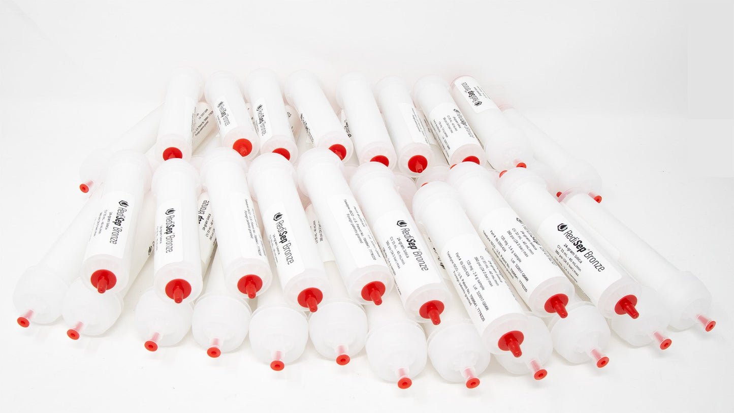 A group of plastic tubes with red caps, positioned side by side, emphasizing their contrasting colors and forms.