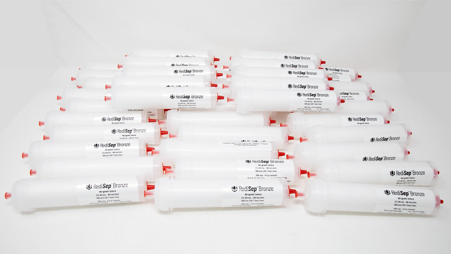 A group of plastic tubes with red caps, positioned side by side, emphasizing their contrasting colors and forms.