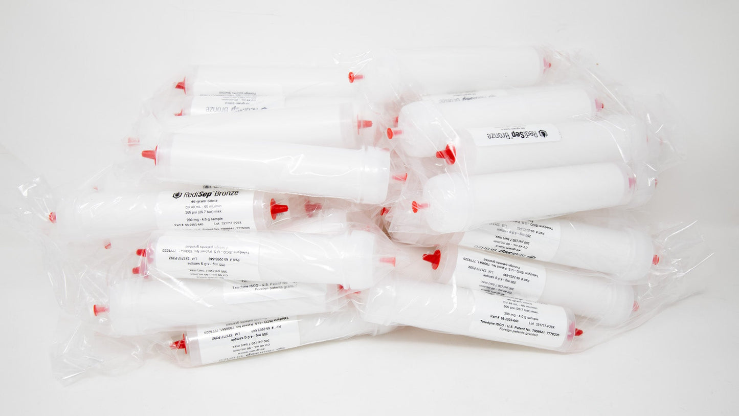 A group of plastic tubes with red caps, positioned side by side, emphasizing their contrasting colors and forms.