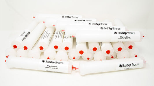 A group of plastic tubes with red caps, positioned side by side, emphasizing their contrasting colors and forms.