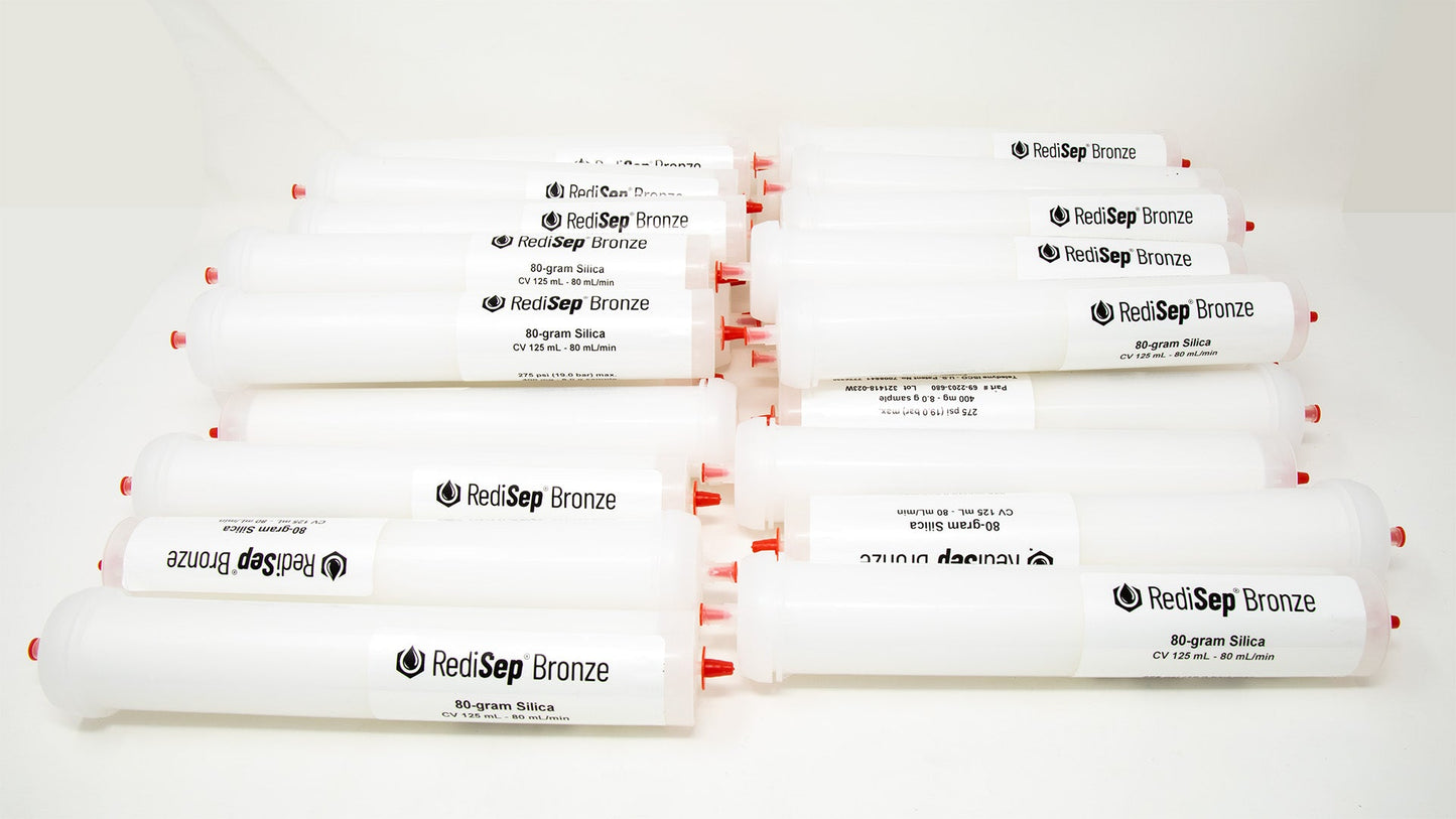 A group of plastic tubes with red caps, positioned side by side, emphasizing their contrasting colors and forms.