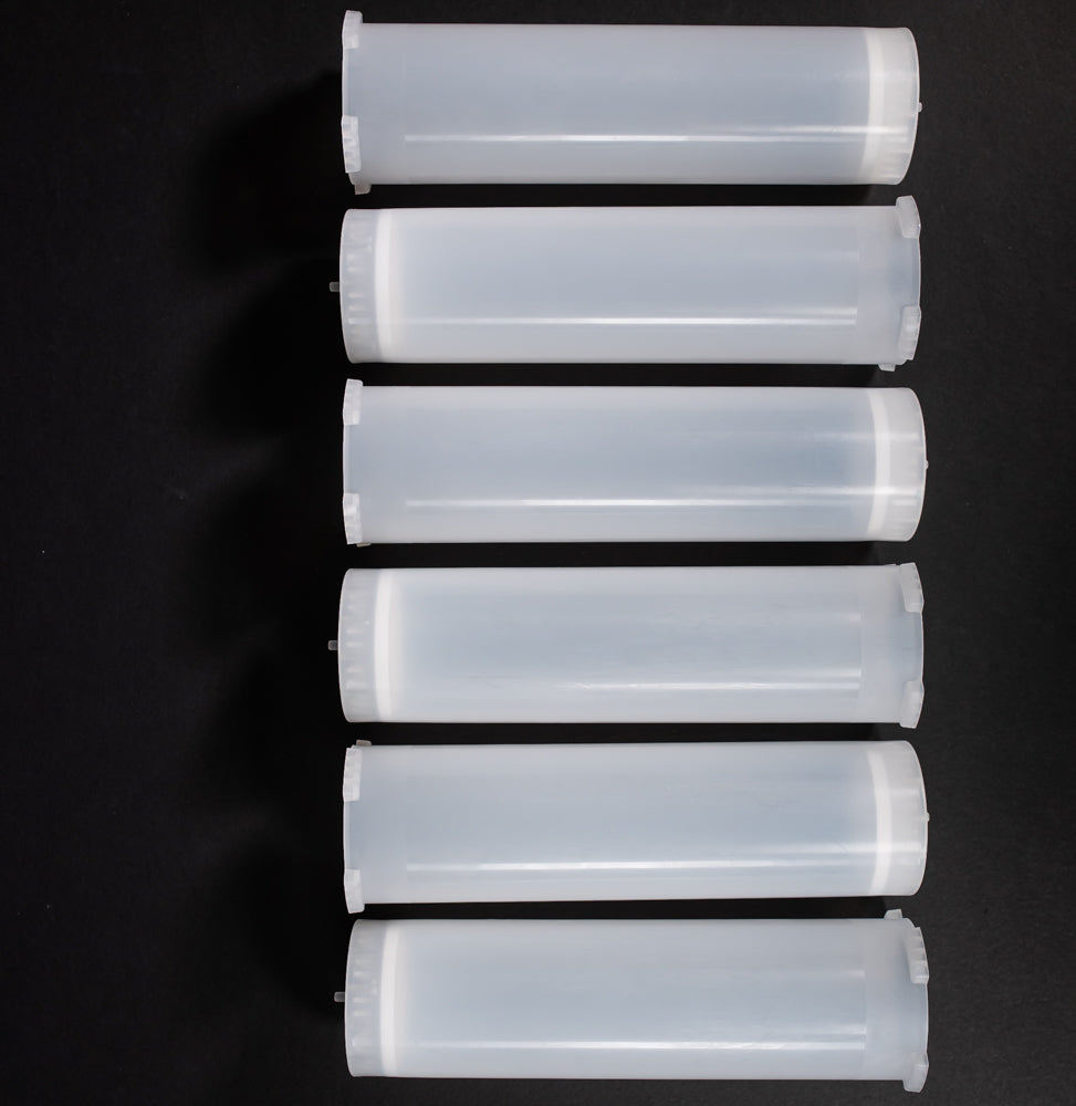 A set of small clear plastic cartridges displayed on a black background, creating a striking visual contrast between the two elements.