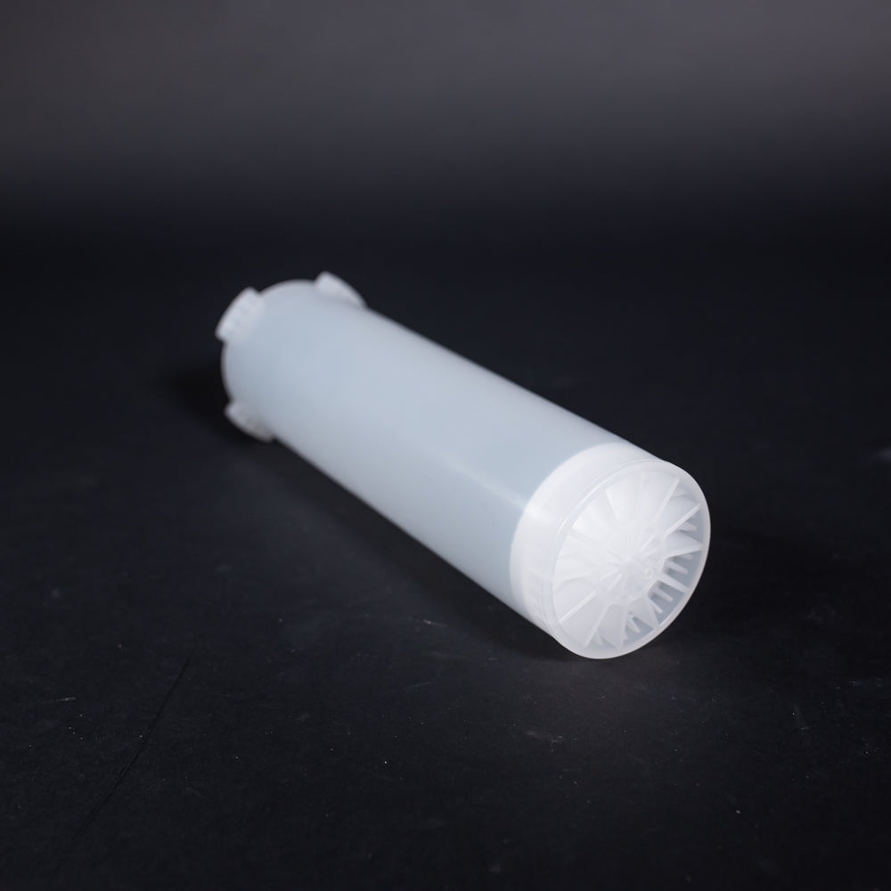 A small clear plastic cartridge displayed on a black background, creating a striking visual contrast between the two elements.