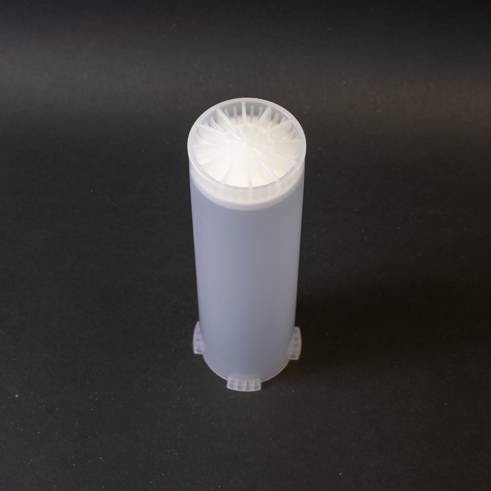 A small clear plastic cartridge displayed on a black background, creating a striking visual contrast between the two elements.