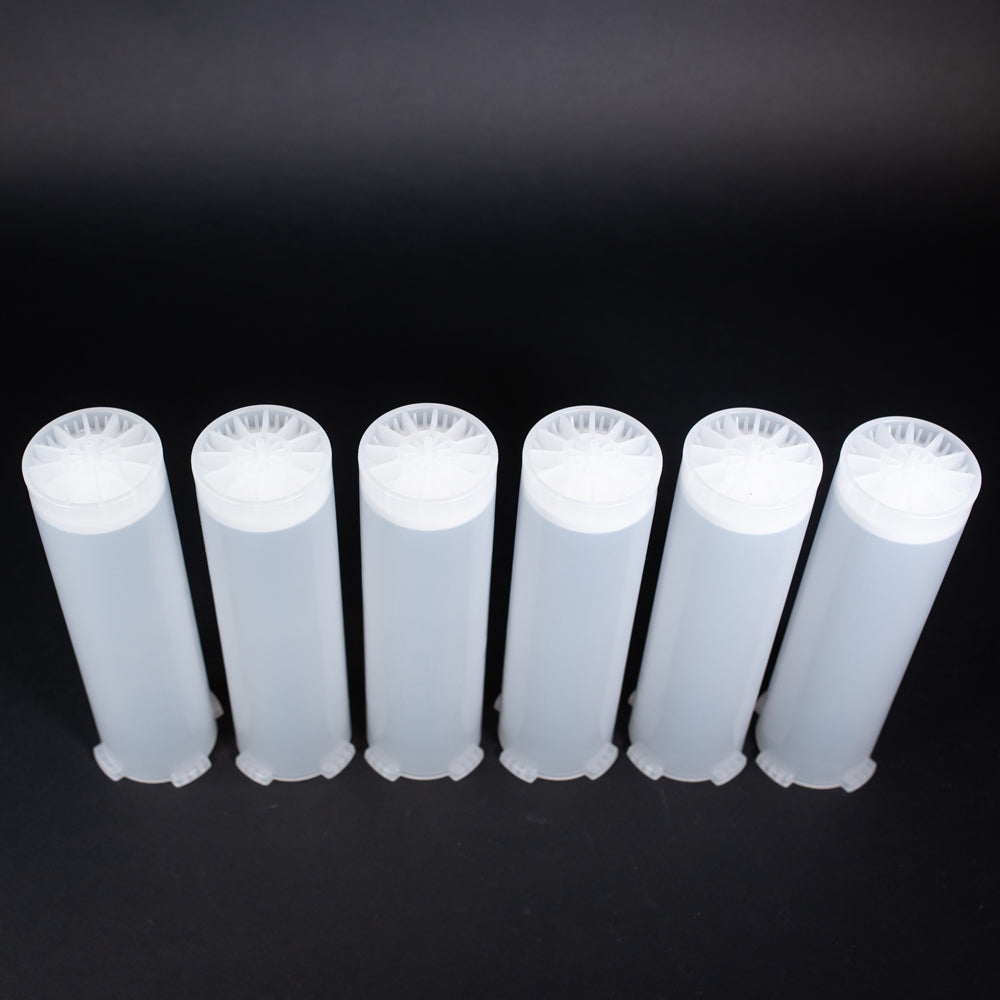 A set of small clear plastic cartridges displayed on a black background, creating a striking visual contrast between the two elements.