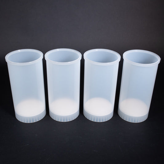 A set of plastic cartridges positioned against a solid black background, creating a striking contrast in colors.