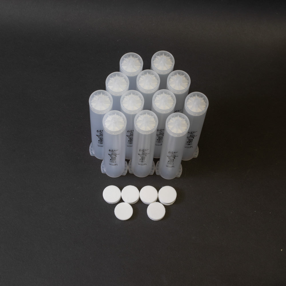 A set of small clear plastic cartridges displayed on a black background, creating a striking visual contrast between the two elements.