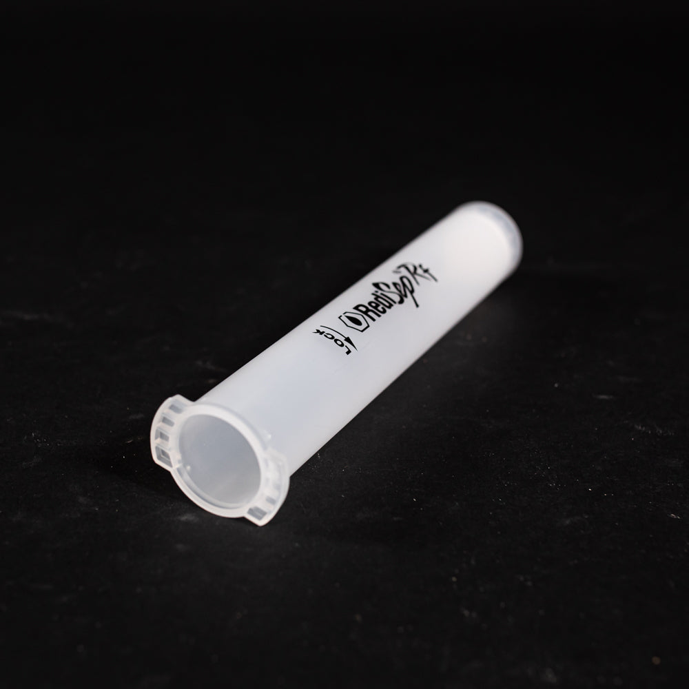 A small clear plastic cartridge displayed on a black background, creating a striking visual contrast between the two elements.