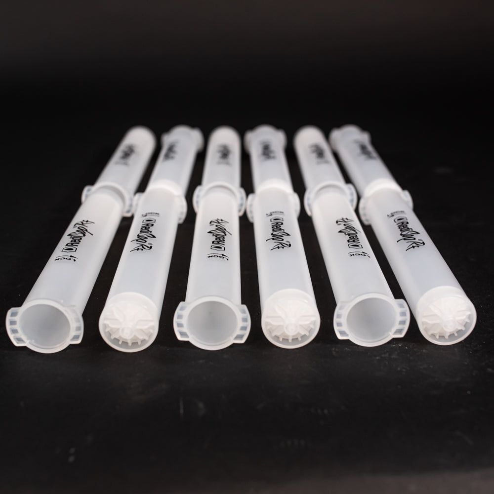 A set of small clear plastic cartridges displayed on a black background, creating a striking visual contrast between the two elements.