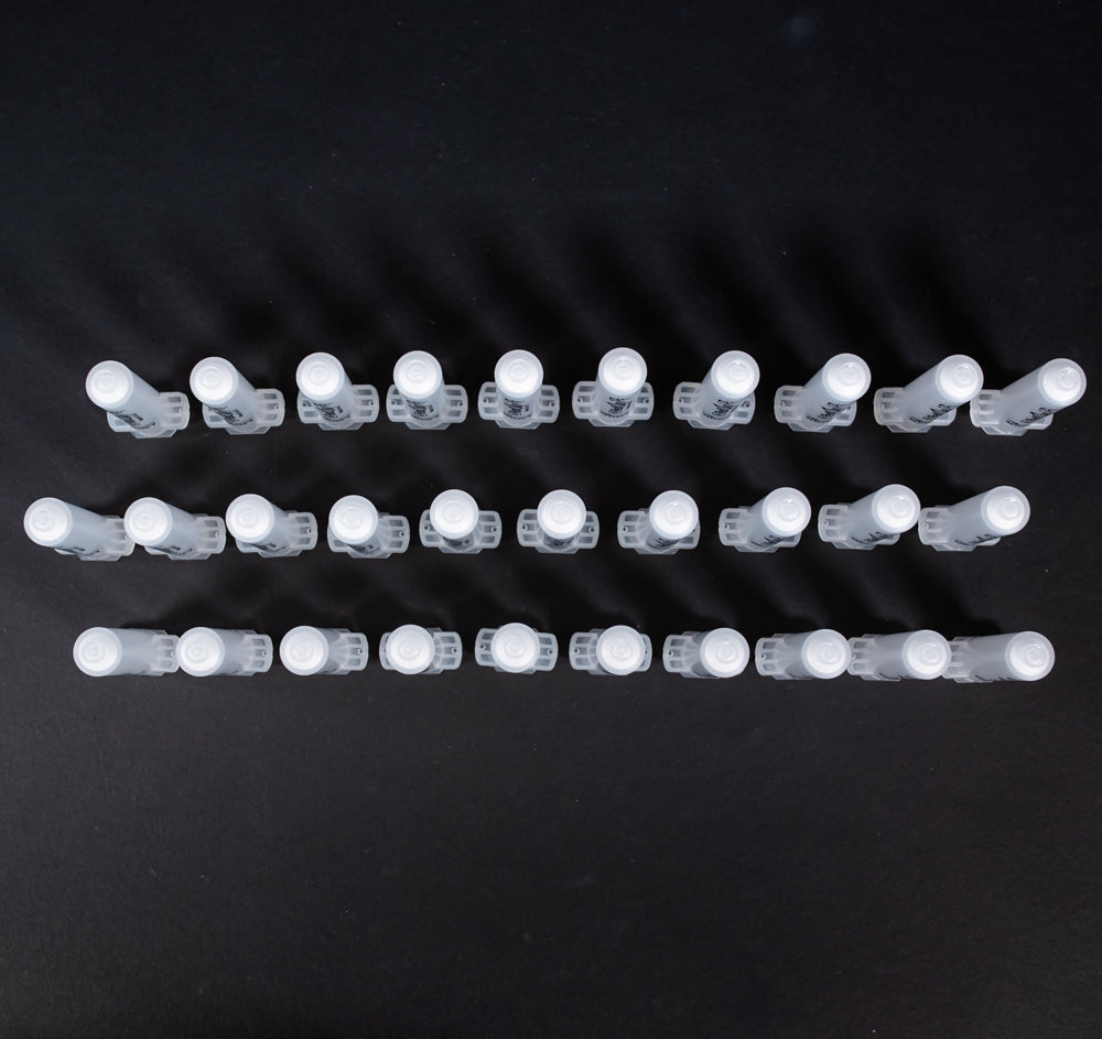 A set of small clear plastic cartridges displayed on a black background, creating a striking visual contrast between the two elements.