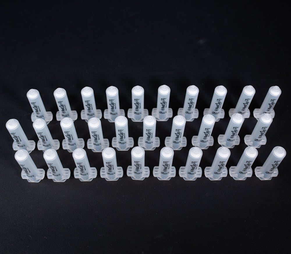 A set of small clear plastic cartridges displayed on a black background, creating a striking visual contrast between the two elements.