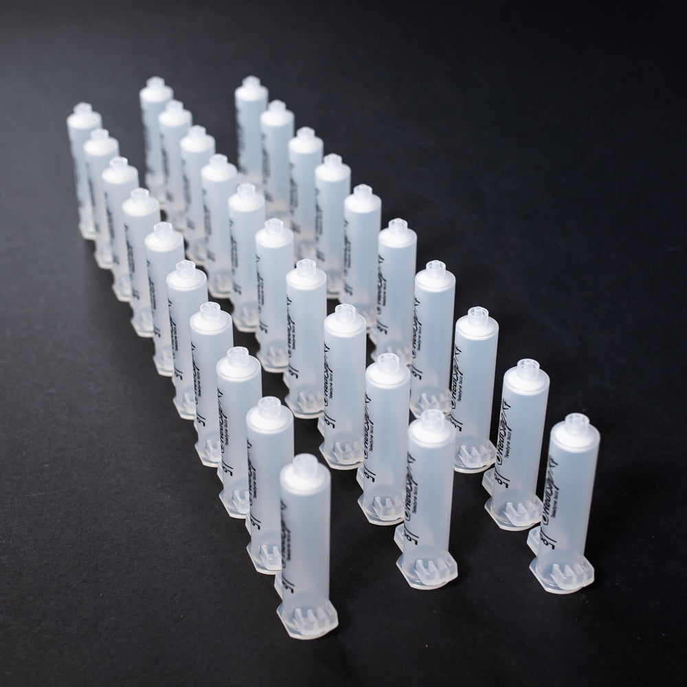 A set of small clear plastic cartridges displayed on a black background, creating a striking visual contrast between the two elements.