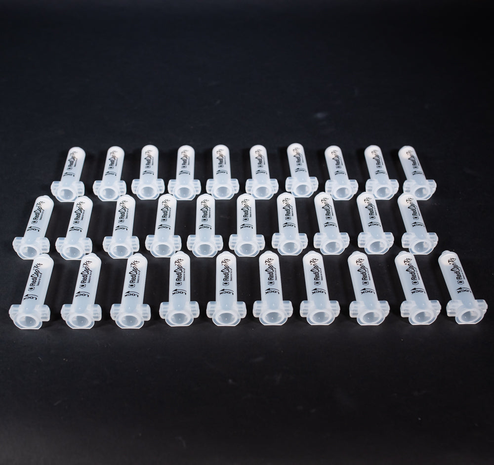 A set of small clear plastic cartridges displayed on a black background, creating a striking visual contrast between the two elements.