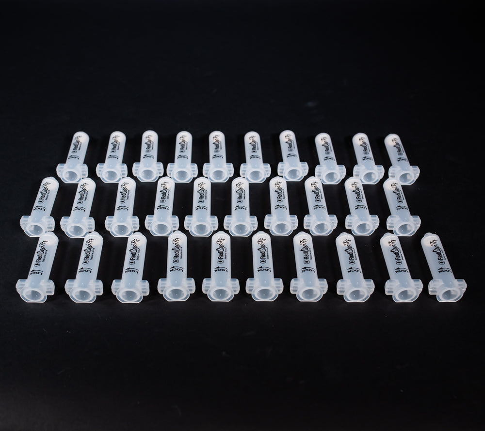 A set of small clear plastic cartridges displayed on a black background, creating a striking visual contrast between the two elements.