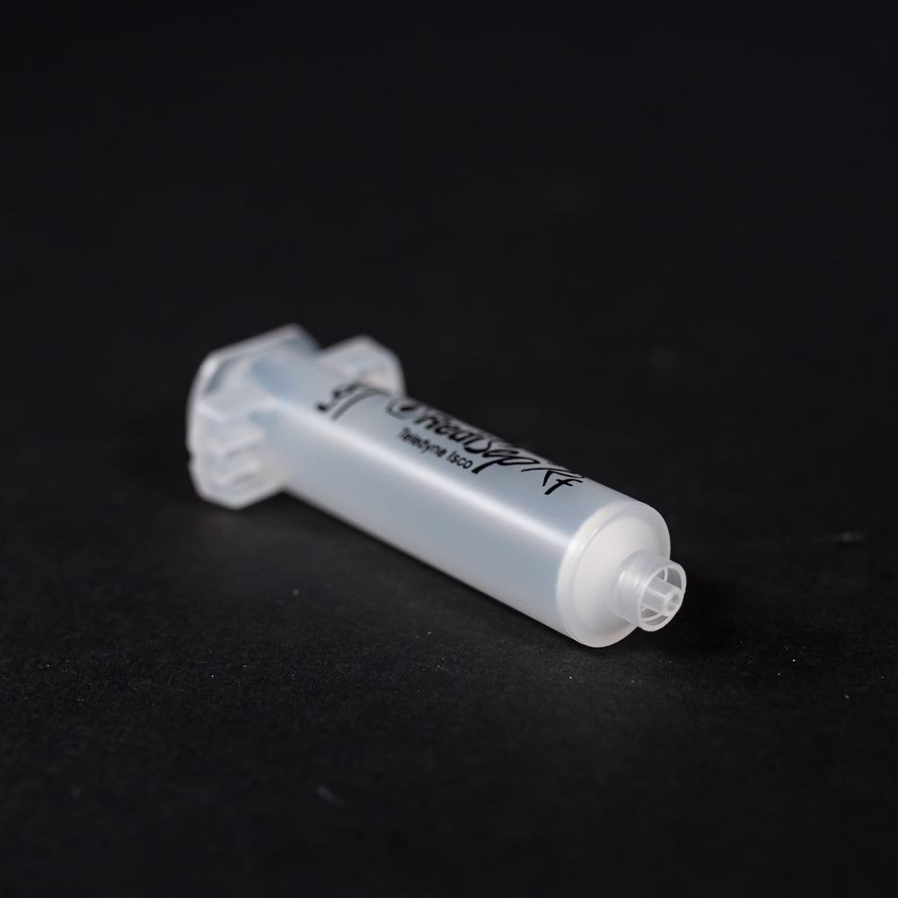 A small clear plastic cartridge displayed on a black background, creating a striking visual contrast between the two elements.