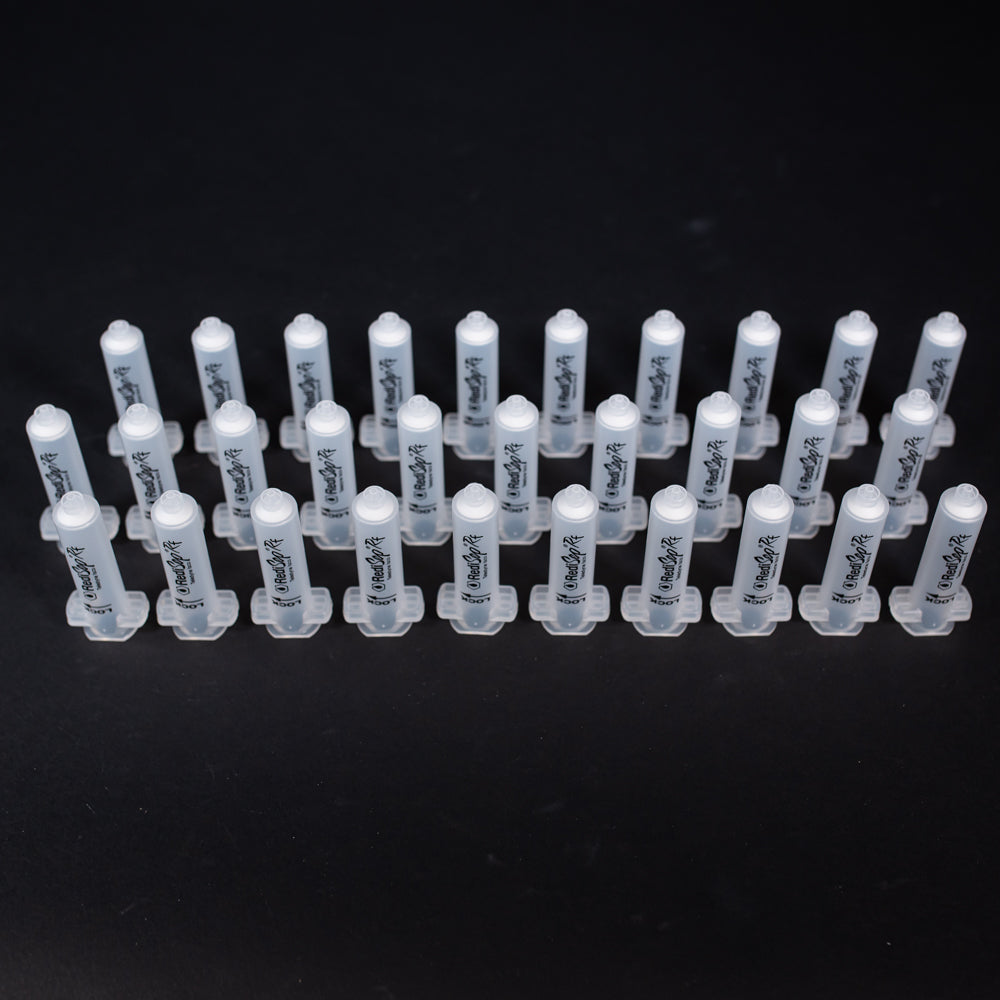 A set of small clear plastic cartridges displayed on a black background, creating a striking visual contrast between the two elements.