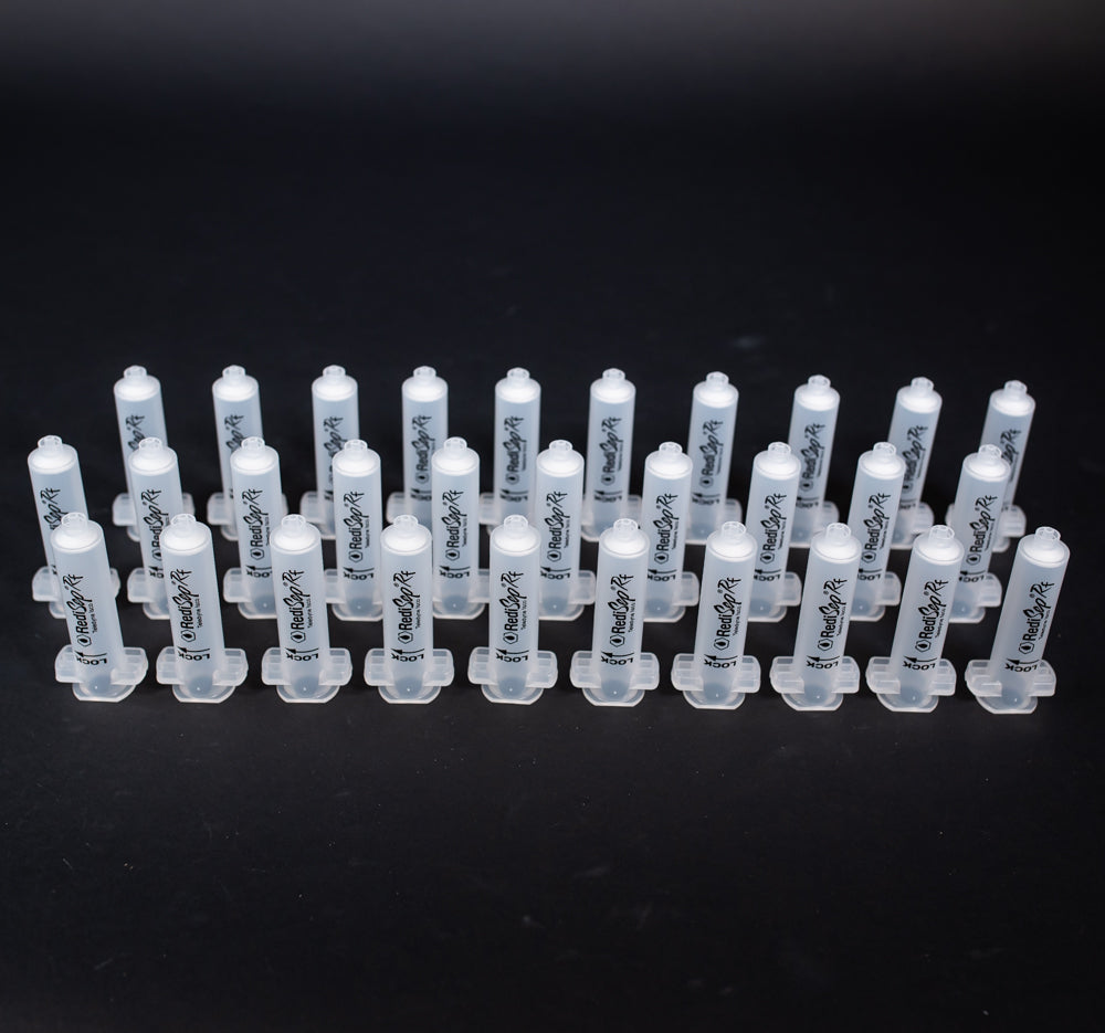 A set of small clear plastic cartridges displayed on a black background, creating a striking visual contrast between the two elements.