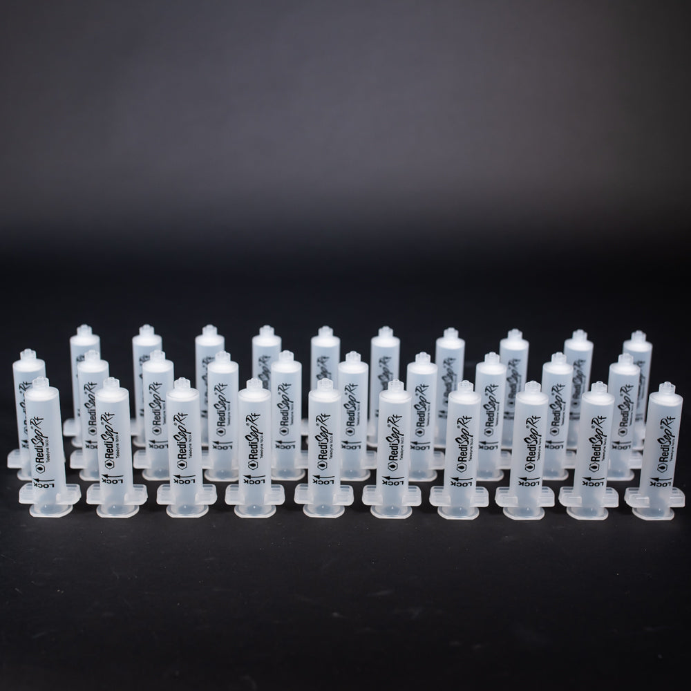 A set of small clear plastic cartridges displayed on a black background, creating a striking visual contrast between the two elements.