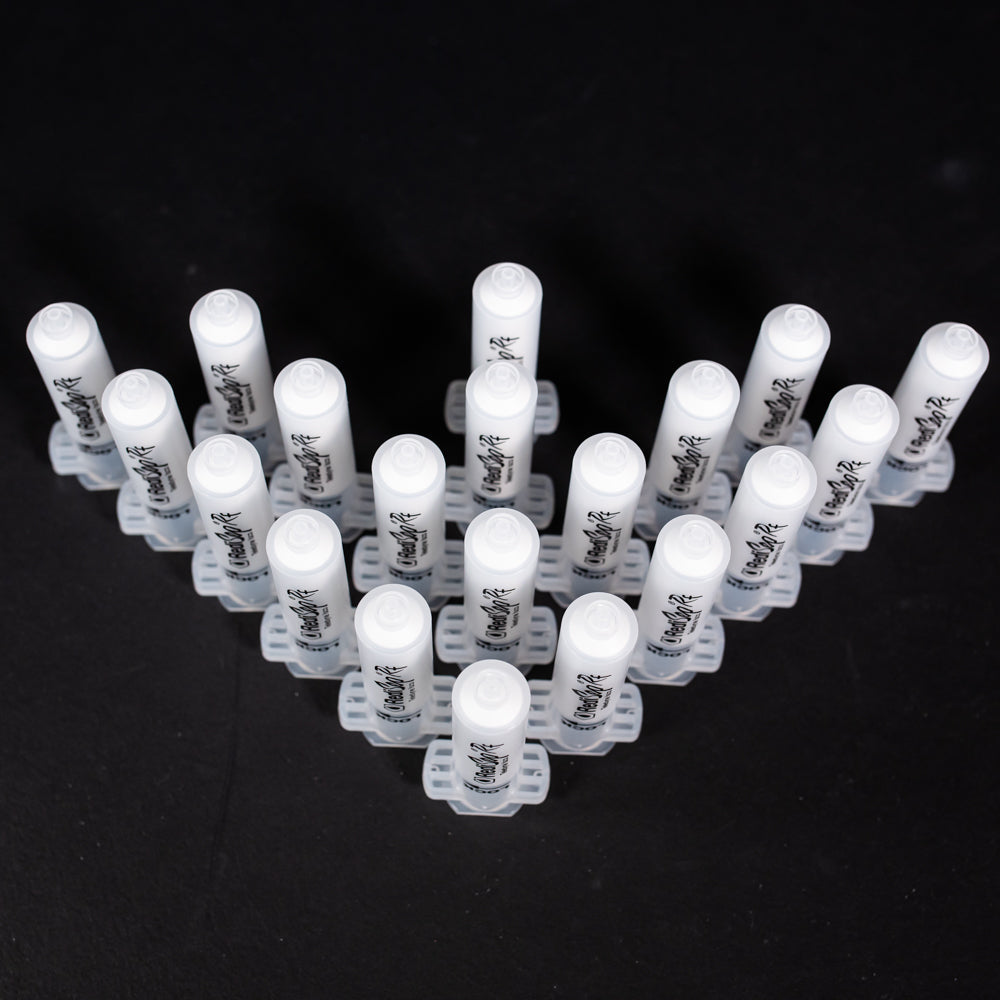 A set of small clear plastic cartridges displayed on a black background, creating a striking visual contrast between the two elements.